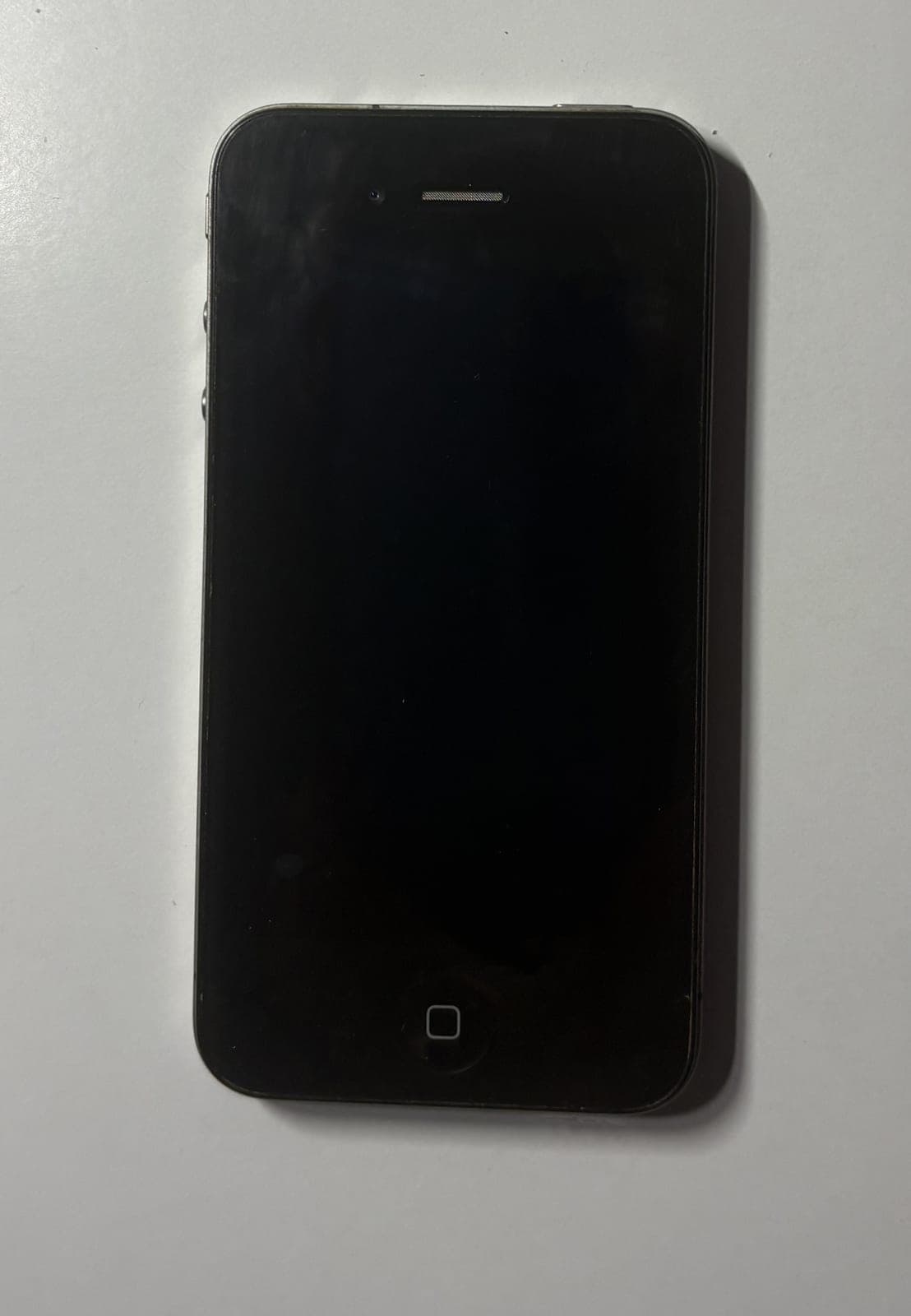 Black iPhone 4 front view on a plain background